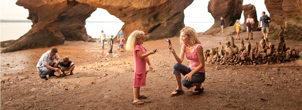 Family vacationing at Hopewell Rocks on the Bay of Fundy